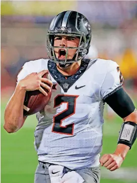  ?? [AP PHOTO] ?? Mason Rudolph’s two touchdown runs against Texas Tech bailed out the Oklahoma State offense after it had begun struggling inside the 20-yard line.