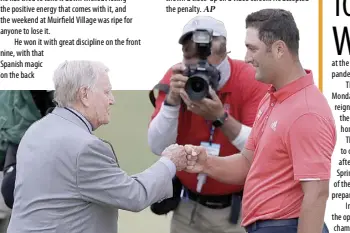  ?? AP ?? JON RAHM fist-bumps the legendary Jack Nicklaus after his victory at the memorial.