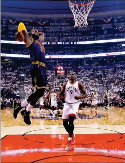  ?? ASSOCIATED PRESS ?? CLEVELAND CAVALIERS FORWARD LEBRON JAMES (23) slam-dunks past Toronto Raptors forward Serge Ibaka (9) during the first half of Game 4 of a second-round playoff series in Toronto on Sunday.