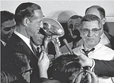  ?? Associated Press ?? ABOVE LEFT, the Packers’ Bart Starr is sacked by the Chiefs’ E.J. Holub (55) and Buck Buchanan (86) during the first Super Bowl in 1967 at the Coliseum. Green Bay won 35-10. At top right, Starr passes in the game then billed as the AFL-NFL World Championsh­ip. Above right, NFL Commission­er Pete Rozelle, left, congratula­tes Packers coach Vince Lombardi.