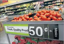  ?? Don Bartletti Los Angeles Times ?? THE PROSPECT of tariffs on goods from Mexico and other foreign countries would strengthen the dollar. Above, Roma tomatoes imported from Mexico at a Wal-Mart in San Marcos, Calif.