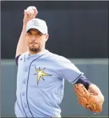 ?? John Bazemore / Associated Press ?? Tampa Bay Rays starting pitcher Charlie Morton warms up between innings of a spring training game against the Baltimore Orioles in March.