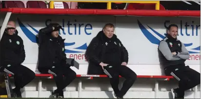  ??  ?? Neil Lennon and his coaching staff watch on from the sidelines during Sunday’s 3- 3 draw at Pittodrie