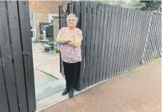  ??  ?? Verna Cole at the back gate from where her wheelie bin was stolen from.