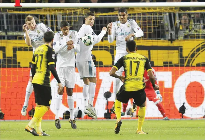  ??  ?? DORTMUND: Real Madrid’s Cristiano Ronaldo, second right rear, jumps to block the ball from a free kick by Dortmund’s Pierre-Emerick Aubameyang, front right, and Dortmund’s Gonzalo Castro, front left, during a Champions League Group H soccer match...