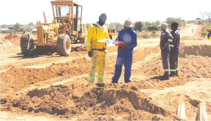  ?? by Memory Mangombe ?? Constructi­on workers rehabilita­te a section of the road linking Birchenoug­h Bridge and Murambinda in Manicaland recently. — Picture