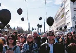  ?? AGGELOS BARAI/AP ?? People obverse a minute of silence at a protest Sunday near the Greek parliament in Athens. Thousands took part in rallies after Greece’s worst recorded rail accident.