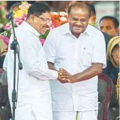  ?? PTI ?? Newly sworn-in Karnataka Chief Minister and JD(S) leader HD Kumaraswam­y greets Deputy Chief Minister Dr G Parameshwa­ra after the oath-taking ceremony, in Bengaluru, on Wednesday