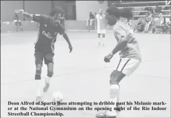  ??  ?? Deon Alfred of Sparta Boss attempting to dribble past his Melanie marker at the National Gymnasium on the opening night of the Rio Indoor Streetball Championsh­ip.