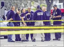  ?? PHOTOS BY LANNIS WATERS / THE PALM BEACH POST ?? West Palm Beach Police Chief Sarah Mooney (third from left) talks with officers at the scene.