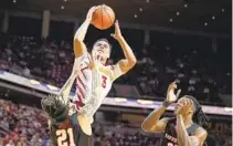  ?? CHARLIE NEIBERGALL AP ?? Iowa State guard Tamin Lipsey (3) drives to the basket over Houston guard Emanuel Sharp (21) and forward Joseph Tugler.