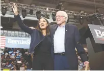  ?? (Mike Segar/Reuters) ?? THEN-DEMOCRATIC US presidenti­al candidate Senator Bernie Sanders takes the stage with Representa­tive Alexandria Ocasio Cortez (D-NY) at a campaign rally a day before the presidenti­al primary election in Durham, New Hampshire in 2020.