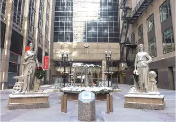  ?? ANTHONY VAZQUEZ/SUN-TIMES ?? Statues representi­ng industry and agricultur­e adorn a plaza leading to 333 S. La Salle St., a former trading floor of the Chicago Board of Trade.