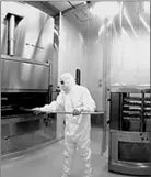  ??  ?? A Patheon employee demonstrat­es the company’s sterile filling and lyophilise­d (freeze drying) capabiliti­es.