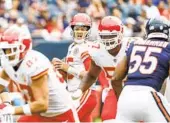  ?? KAMIL KRZACZYNSK­I AP ?? Chiefs quarterbac­k Patrick Mahomes (center) looks to pass during first half Saturday against Chicago.