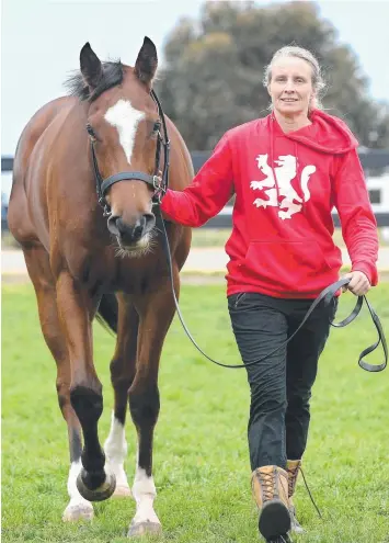  ?? Picture: GLENN FERGUSON ?? HIGH-FLYER: Rosemont Stud operations manager Janelle Young with two-year-old filly Luck Favours, who will race at Royal Ascot next month.