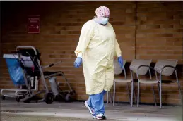  ?? CP PHOTO JONATHAN HAYWARD ?? A health care worker is seen outside the Lions Gate Hospital in North Vancouver on Tuesday.