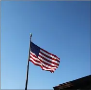 ?? JEN SAMUEL — MEDIANEWS GROUP ?? An American flag flies in Kennett Square. Today is Election Day, and area police chiefs say they expect a peaceful vote.