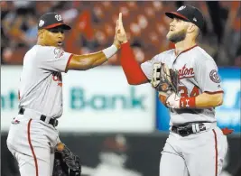  ?? Jeff Roberson ?? The Associated Press Bryce Harper, right, greets Nationals teammate Wilmer Difo after Washington’s 5-4 win over the Cardinals on Thursday at Busch Stadium. Harper had three RBIS.