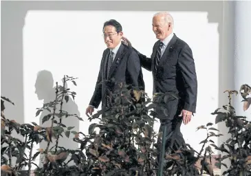  ?? ?? FRIENDS IN WASHINGTON: US President Joe Biden pats Japan’s Prime Minister Fumio Kishida on the back as they walk down the West Wing Colonnade to the Oval Office of the White House in Washington on Friday.