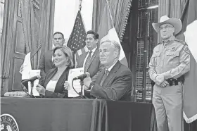  ?? ACACIA CORONADO/REPORT FOR AMERICA/VIA AP ?? Texas Gov. Greg Abbott signs a border security agreement with Chihuahua Gov. Maru Campos Galvan on Thursday.