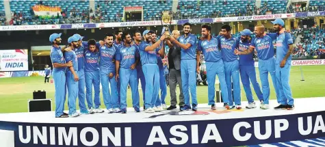  ?? Virendra Saklani/Gulf News ?? India celebrate during the trophy presentati­on ceremony after winning the Unimoni Asia Cup tournament. They defeated Bangladesh by three wickets at the Dubai Internatio­nal Cricket Stadium on Friday.