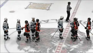  ?? NEWS PHOTO JAMES TUBB ?? The Medicine Hat Tigers and Winnipeg Ice meet at centre ice for a post-series handshake following Winnipeg’s 3-2 Game 4 win on April 5, 2023 to sweep their first round series 4-0.