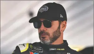  ?? The Associated Press ?? 30TH TO 600: Jimmie Johnson climbs into his car Saturday prior to practice for today’s NASCAR Cup Series race in Long Pond, Pa. Johnson will be the 30th driver in NASCAR history to make 600 career starts.