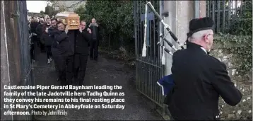  ?? Photo by John Reidy ?? Castlemain­e Piper Gerard Baynham leading the family of the late Jadotville hero Tadhg Quinn as they convey his remains to his final resting place in St Mary’s Cemetery in Abbeyfeale on Saturday afternoon.