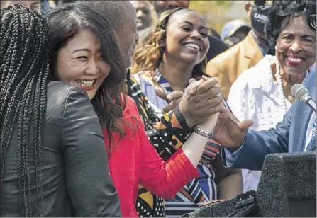  ?? Mel Melcon Los Angeles Times ?? SHINESE HARLINS-KILGORE, left, cousin of Latasha Harlins, hugs Hyepin Im, founder of Faith and Community Empowermen­t, while Lora Dene King, center, daughter of Rodney King, smiles during a news conference commemorat­ing the riots’ 30th anniversar­y.