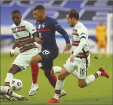  ?? ASSOCIATED PRESS ?? FRANCE’S KYLIAN MBAPPE drives the ball past Portugal’s Bernardo Silva (right) during the UEFA Nations League match between France and Portugal at the Stade de France in SaintDenis, north of Paris, France, Sunday.