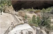  ?? LUIS SÁNCHEZ SATURNO NEW MEXICAN FILE PHOTO ?? Hikers climb down from the Alcove House at Bandelier National Monument in June 2021. A strict plan to limit flights over the monument is part of a wider federal rule meant to limit site noise.