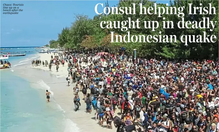  ??  ?? Chaos: Tourists line up on a beach after the earthquake