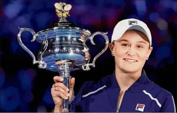  ?? Hamish Blair / Associated Press ?? Australia’s Ash Barty celebrates with the Daphne Akhurst Memorial Cup after defeating American Danielle Collins, 6-3, 7-6 (2) in the women's final on Saturday in Melbourne.