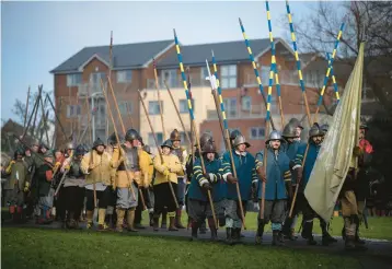  ?? OLI SCARFF/GETTY-AFP ?? Weekend warriors: Members of the Sealed Knot, a society promoting interest in the English Civil War, gather Saturday in Nantwich, England, to stage their 50th reenactmen­t of the Battle of Nantwich in 1644. The town, loyal to Parliament in the war, was under siege for weeks by royalist troops until a Parliament­arian force prevailed in the battle.