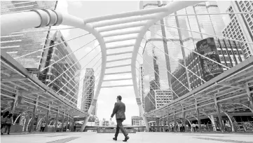  ?? — Reuters photo ?? A man walks in business area in Bangkok, Thailand. Even as the rest of the world feels the pinch of Beijing’s clampdown on outbound capital, China is ploughing money into Southeast Asia – much of it into infrastruc­ture projects related to President Xi...