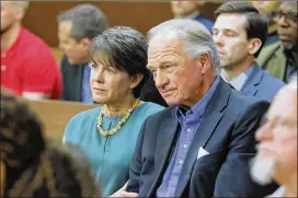  ?? BOB ANDRES PHOTOS / BANDRES@AJC.COM ?? Waffle House chairman Joe Rogers Jr. (right), and his wife, Fran, react to the verdict. Joe Rogers still has a lawsuit pending against his former housekeepe­r, Mye Brindle, in Cobb County, as she does against him as well.