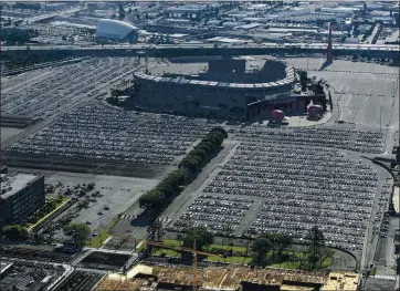  ?? JEFF GRITCHEN — SOUTHERN CALIFORNIA NEWSPAPER GROUP ?? Thousands of rental cars sit in the parking lot of Angel Stadium in Anaheim due to the coronaviru­s last May. Rental cars were sold as companies needed money to ride out the pandemic. Now supply is scarce as travel has increased recently.