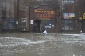  ?? Photograph: Peggy Fagerstrom/AP ?? Remnants of Typhoon Merbok flooded Alaska, causing damage and power outages and leaving residents to wonder how to survive the winter.