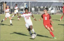  ?? COURTESY OF CRAIG FRY/AWC PHOTOGRAPH­ER ?? ARIZONA WESTERN’S LINDA OBARE (23) and Cochise’s Sofia Gallegos (8) chase after the ball during Thursday’s game at AWC.