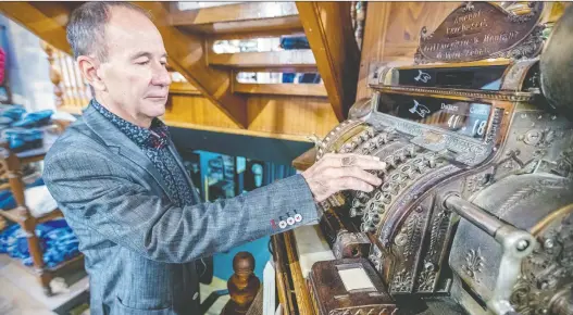  ?? JOHN MAHONEY ?? Philippe D'aoust, owner of G. Daoust & Cie., with the 1912 cash register in the department store his grandfathe­r founded in Ste-anne-de-bellevue.