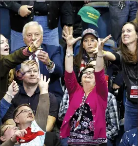  ?? AP/MARK HUMPHREY ?? People reach for a cap thrown into the crowd before the start of a rally Sunday with President Donald Trump in Chattanoog­a, Tenn. Trump was in Tennessee to campaign for Republican Marsha Blackburn in her bid for the U.S. Senate.