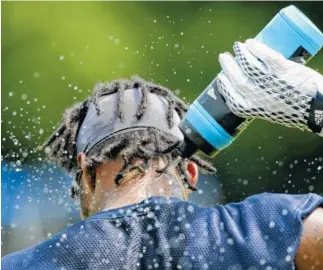  ?? STAFF PHOTO BY C.B. SCHMELTER / ?? UTC defensive back Cameron Turner sprays water on the back of his neck during the first day of preseason practice at Scrappy Moore Field on Monday.