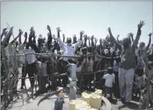  ?? COURTESY PHOTO BURNING BUSH INTERNATIO­NAL ?? Ugandan villagers celebrate their new well.