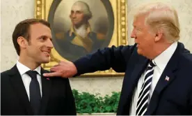  ?? Photograph: Kevin Lamarque/Reuters ?? Donald Trump flicks what he said was a bit of dandruff off Emmanuel Macron’s jacket.