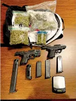  ?? Submitted photo ?? Nearly a half-pound of marijuana and two guns which reportedly resulted in the arrest of a local teen on Cooper Street on numerous felony charges are displayed.