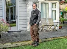  ?? PHOTO: JOHN KIRK-ANDERSON/STUFF ?? Eastern Tce, Beckenham, resident Hugo Young in front of his house, which came within an inch of succumbing to floodwater­s on Saturday.