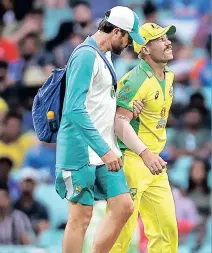  ??  ?? David Warner grimaces in pain as he leaves the field during the second ODI