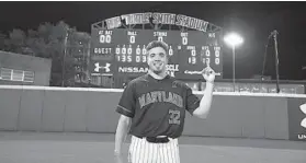  ?? JOE NOYES/MARYLAND ATHLETICS ?? Maryland pitcher Ryan Ramsey poses in front of the scoreboard on Shipley Field at Bob “Turtle” Smith Stadium after throwing the 34th NCAA Division I perfect game in a 13-0 victory over Northweste­rn on Friday night in College Park.