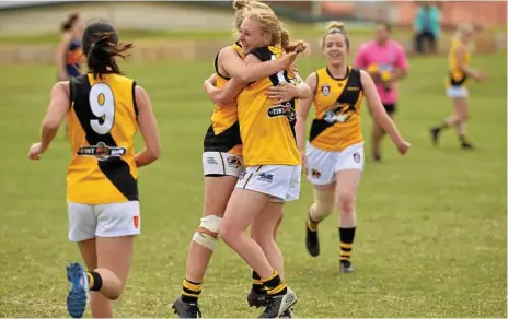  ?? Photo: Kevin Farmer ?? THROUGH THE BIG STICKS: Toowoomba Tigers players celebrate a Jessica Moon (centre) goal against University. The Tigers prevailed against the Cougars by 28 points.